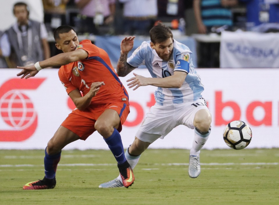 Argentina's Lionel Messi takes on Chile's Alexis Sanchez during the first half