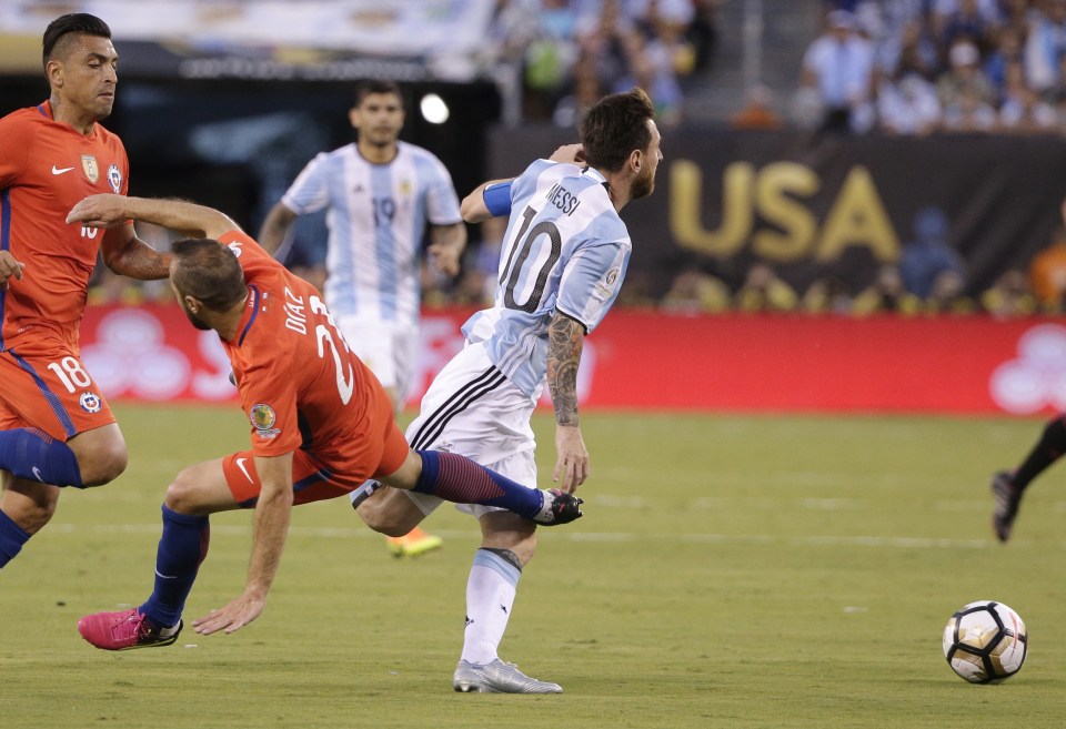 Lionel Messi is brought down by Marcelo Diaz in the first of his two yellow cards