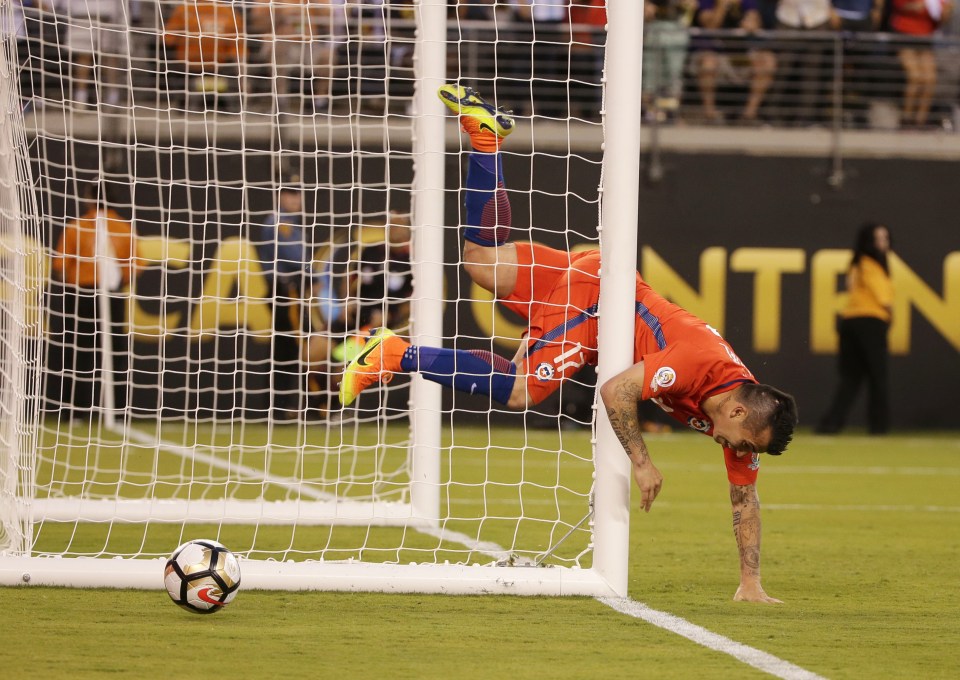 Gary Medel makes sure Gonzalo Higuain's shot doesn't go in but collides with the post