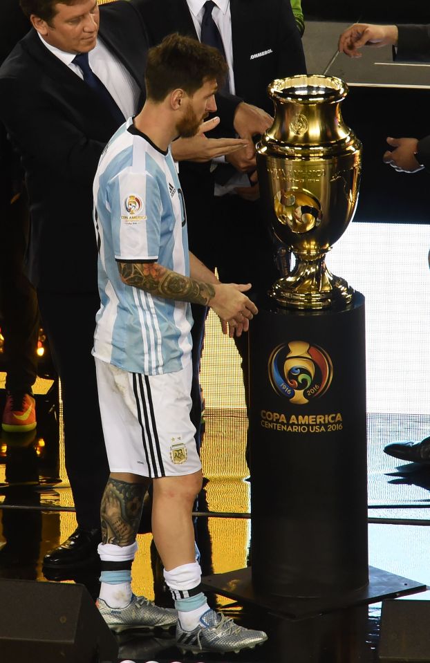 Messi walks past the Copa America trophy after Argentina were beaten in the final