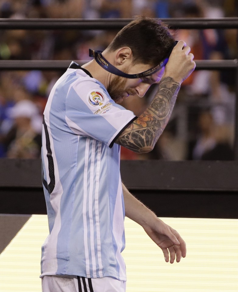 Messi removes his runners-up medal after another heartbreaking final defeat