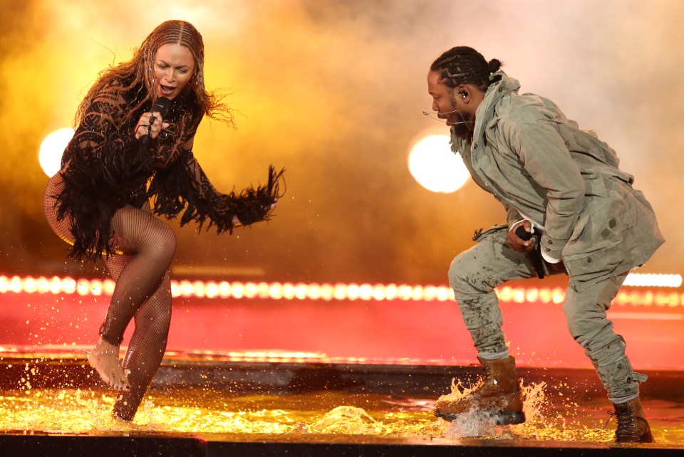  The two stomp through the water on stage