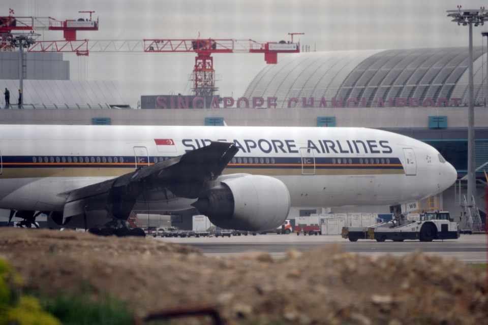 The charred wing can be seen on the plane at Changi Airport