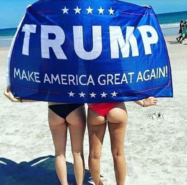  Two women hide under a Trump banner and showcase their bottoms