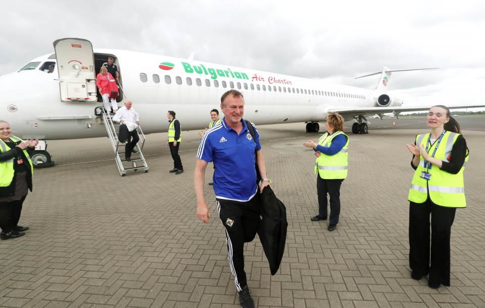  Michael O'Neill managed a faint smile upon arrival in Belfast airport