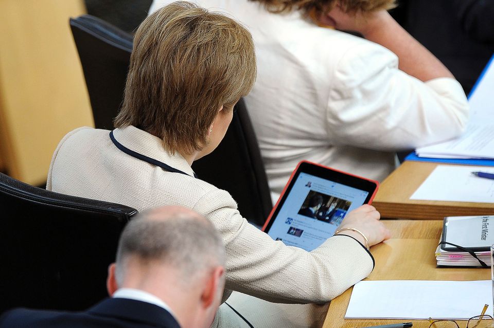  #EUref: Nicola Sturgeon checks her Twitter feed during a break in the debate on the EU Referendum result