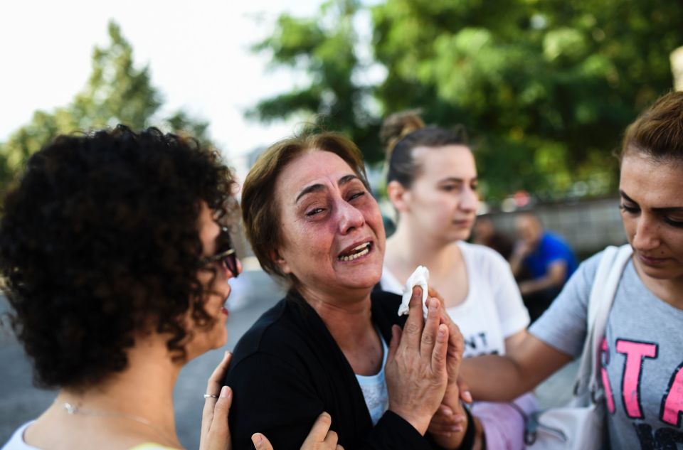  Grief: A mother of one of the victims killed in the suicide bombings is comforted as she breaks down in tears