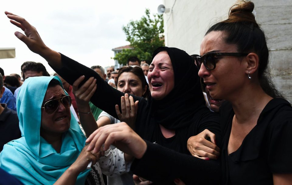  Torment: The daughter (centre) of Siddik Turgan, a man killed in the ISIS massacre at Ataturk Airport, breaks down as her father's coffin is carried during his funeral ceremony in Istanbul