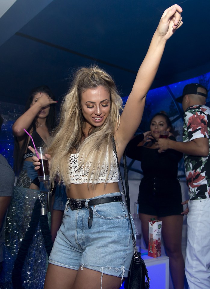  Holly showed off her dance moves and svelte figure in tiny denim shorts and a white crop top