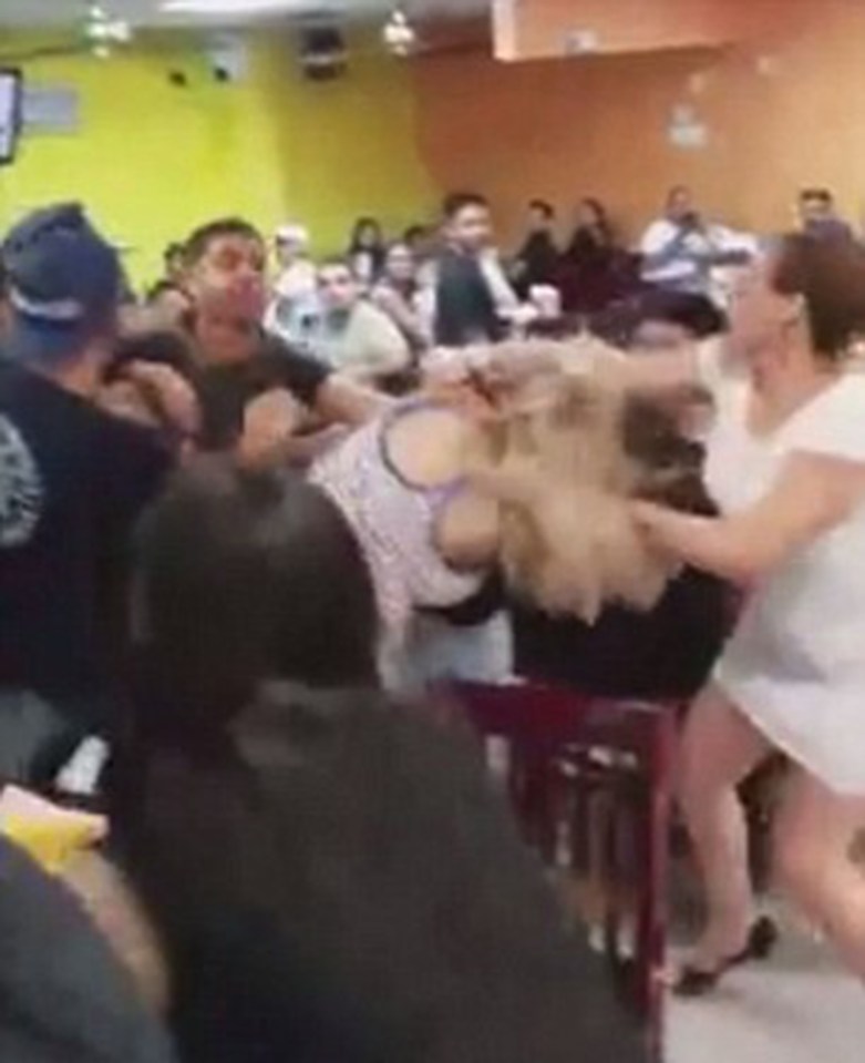  A group of women start the fight and tug chunks out of each other's hair