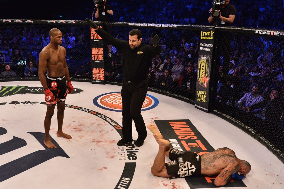  Down and out: Michael Page stands off as referee John McCarthy waves the fight off