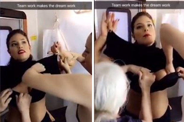 Gorgeous plus-size model Ashley Graham is helped into a bra by THREE assistants