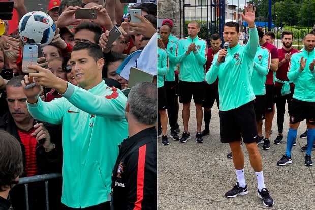 Cristiano Ronaldo takes selfies with fans during Portugal training