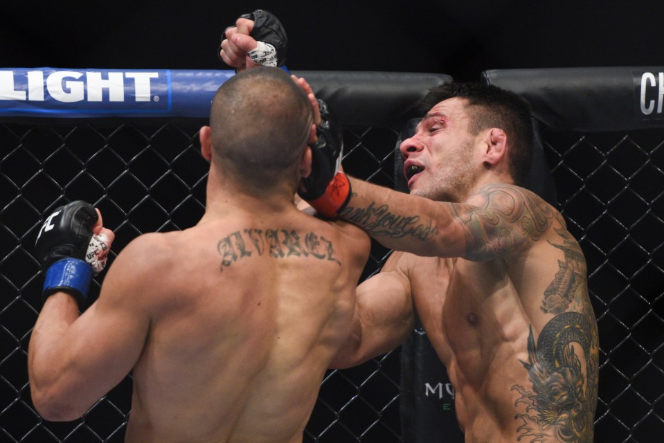  Hammer blow: Eddie Alvarez lands a huge uppercut on Rafael dos Anjos