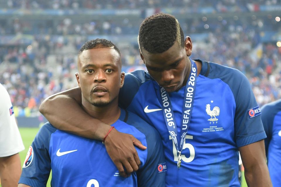 TOPSHOT - France's defender Patrice Evra (L) and France's midfielder Paul Pogba look dejected as they leave the pitch after Portugal won the Euro 2016 final football match between Portugal and France at the Stade de France in Saint-Denis, north of Paris, on July 10, 2016. / AFP / PATRIK STOLLARZ (Photo credit should read PATRIK STOLLARZ/AFP/Getty Images)