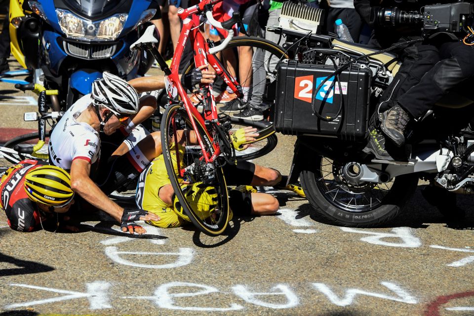 Chris Froome, Bauke Mollema and Richie Porte (left) try to get up after the motorbike crash caused them to hit the deck