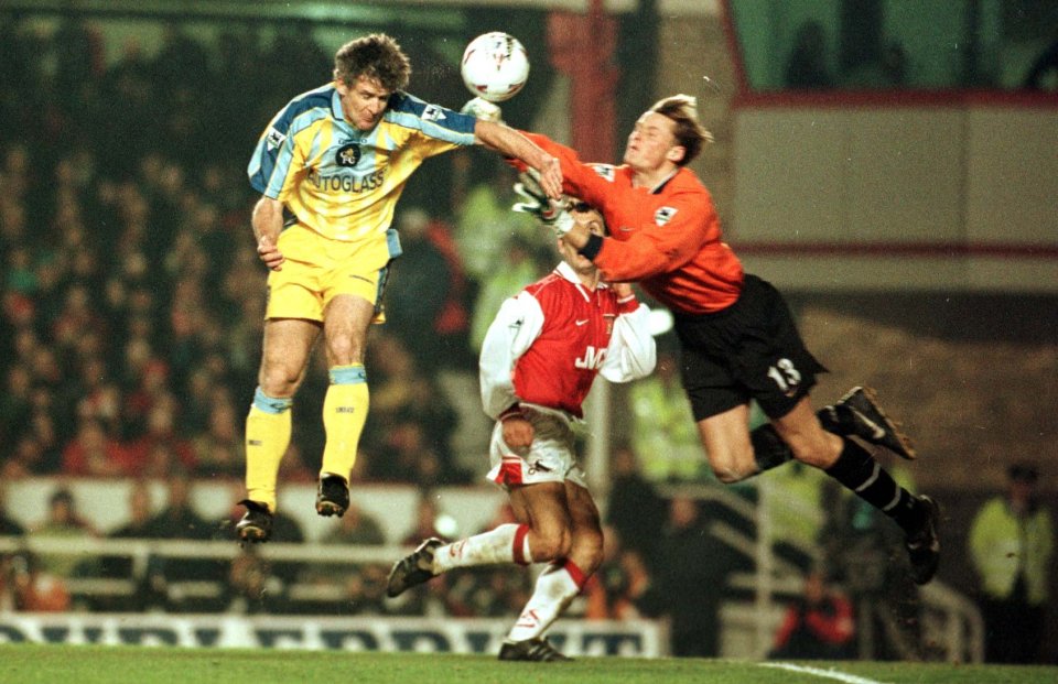 Mark Hughes of Chelsea jumps above Manninger to head home in 1998