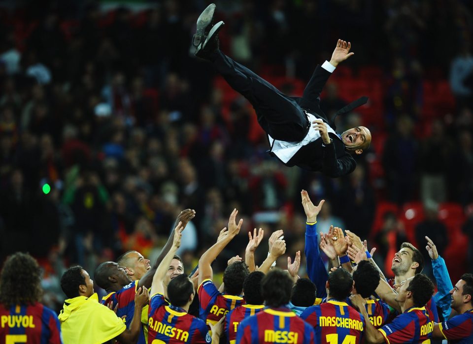  Guardiola is thrown in the air by Barcelona players after their 2011 Champions League triumph over Manchester United at Wembley