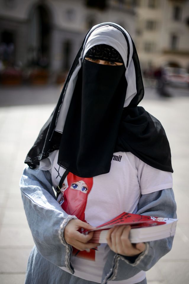 Islamic Central Council of Switzerland (ICCS - CCIS) member Nora Illi, one of the few Swiss women wearing the niqab, distributes flyers in Lugano against an upcoming cantonal vote on banning face-covering headgear