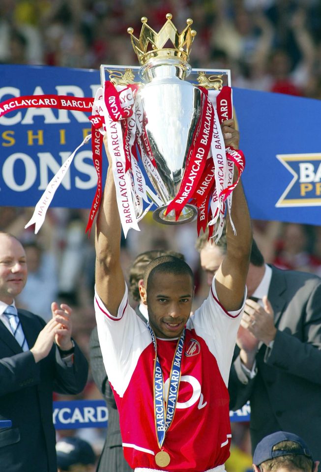  French star Henry with one of the two Prem titles he won with the Gunners