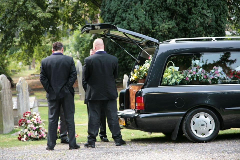 funeral directors and pall bearers preparing to remove coffin from hearse. Image shot 2006. Exact date unknown.