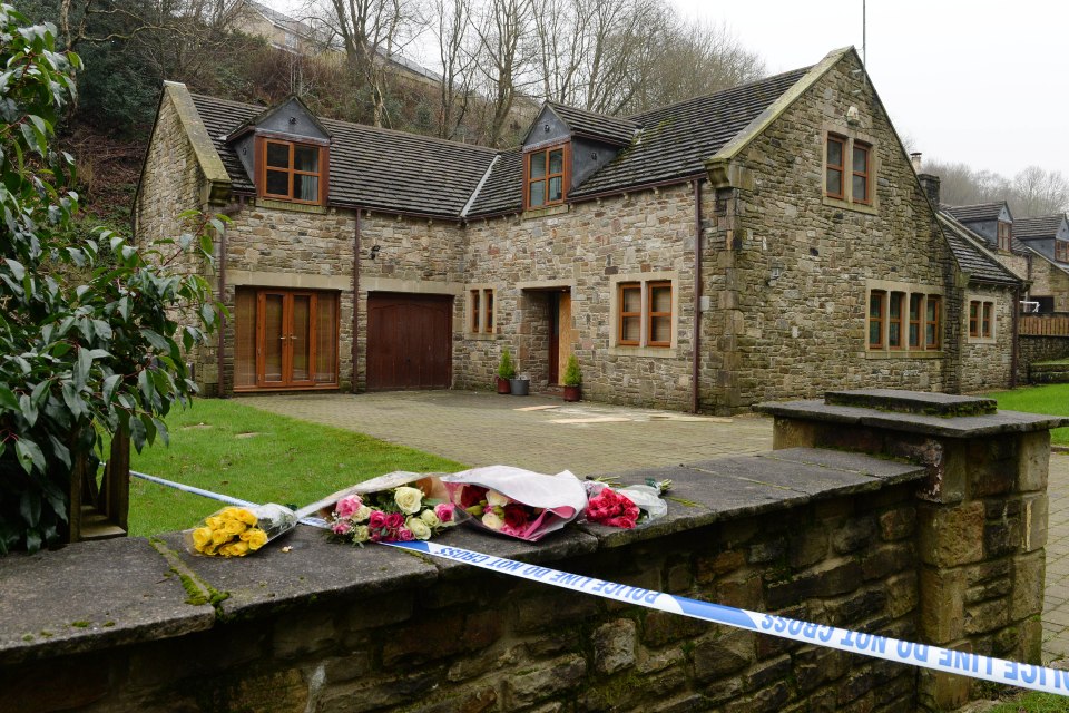  Floral tributes lie on the wall outside the home Sadie Hartley shared with partner Ian in Helmshore, Lancashire