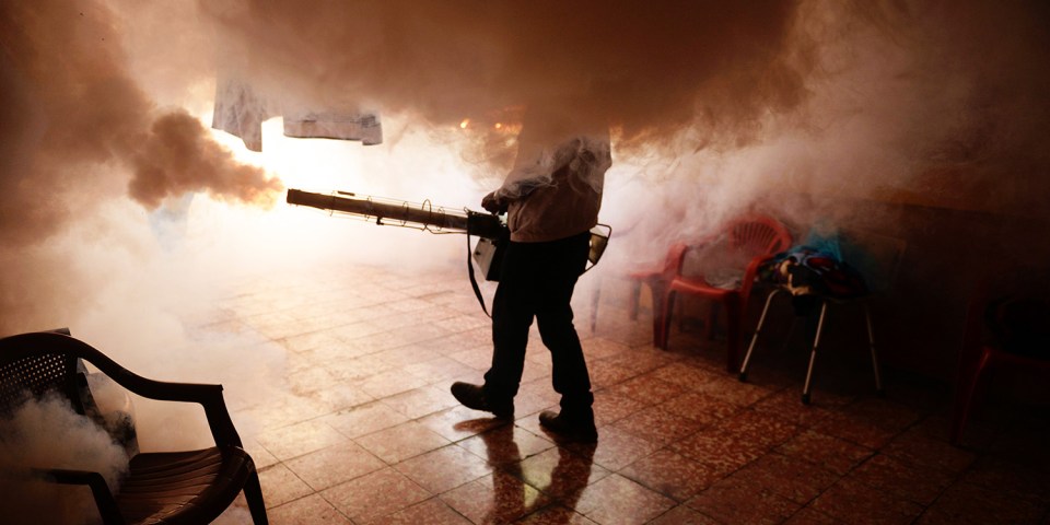  A Health Ministry employee fumigates a home against Zika-carrying mosquitoes to prevent the spread of the virus