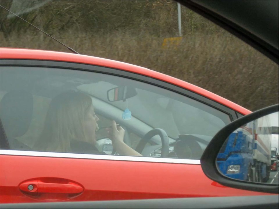 A WOMAN eats pasta at the wheel with a fork doing speeds of up to 50mph on a motorway. The Ford Fiesta driver was filmed on a lorrys dashcam as she joined the M60 in Manchester, holding the bowl in her left hand.