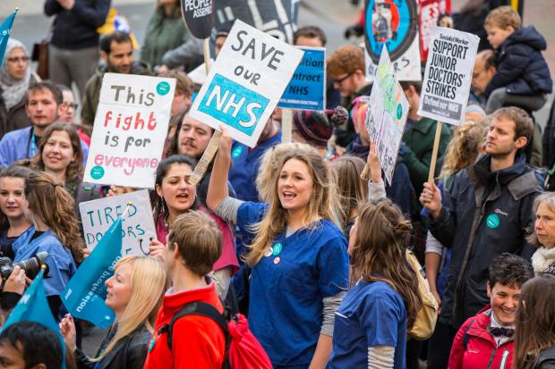 Bristol, UK. 26th April, 2016. Hundreds joined a protest march through Bristol at the end of the first day of a two-day all-out junior doctors strike. The lively marchers chanted slogans in support of the striking doctors. Bristol, UK. 26th April 2