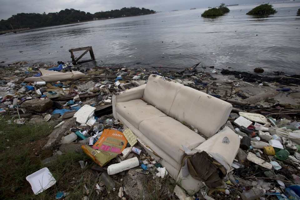  A discarded sofa is pictured among the rubbish scattered on the shore of Guanabara Bay