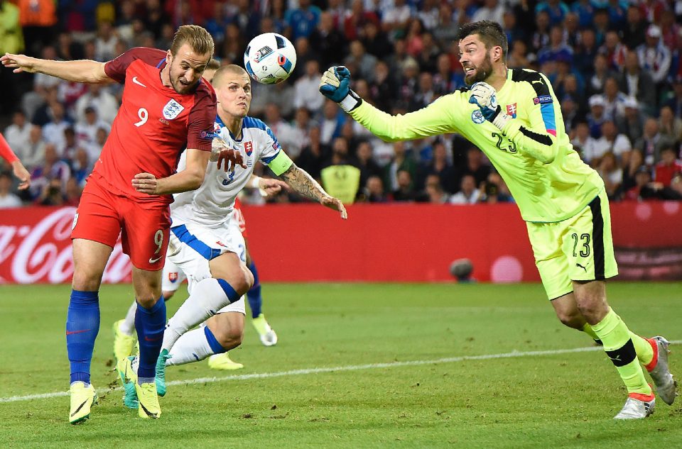  Slovak keeper Matus Kozacik punches the ball clear of Kane in France