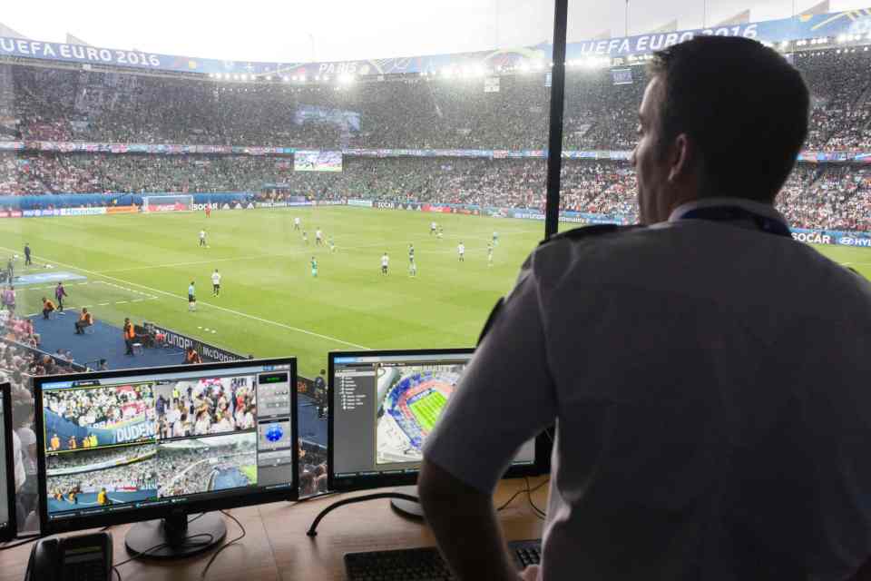 A French police officer watches surveillance screens in the control center at the Parc des Princes