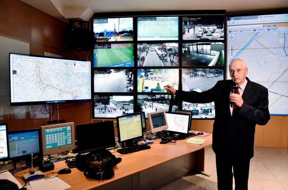 Paris's prefect Michel Cadot standing next to surveillance screens at the Police prefecture in Paris