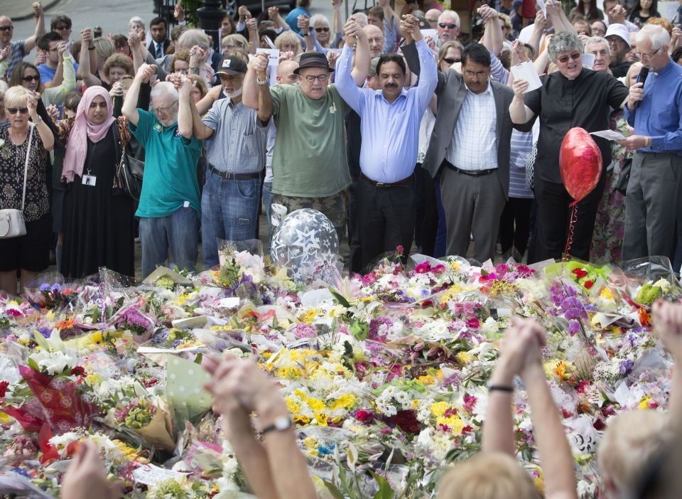  Members of the public joined hands as they paid tribute to the murdered MP Jo Cox who was shot and stabbed in Birstall, West Yorkshire