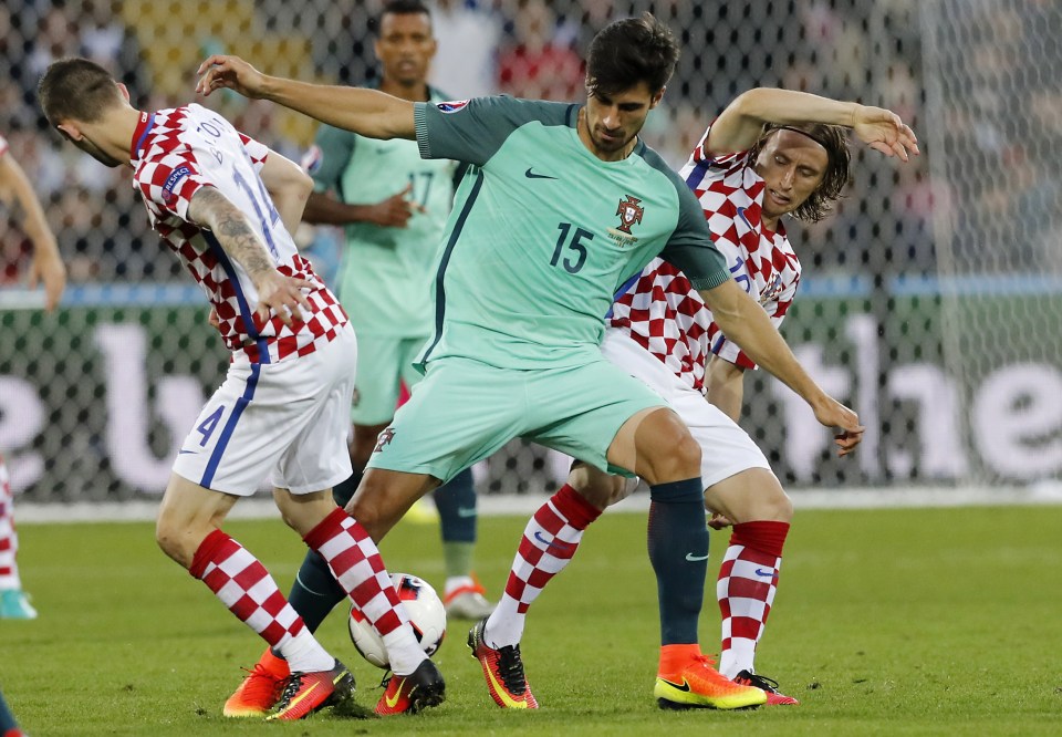  Andre Gomes holds off Ivan Perisic and Luka Modric as Portugal take on Croatia at Euro 2016