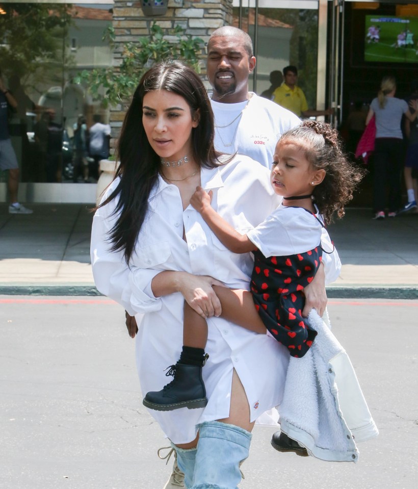  Happy families: Kim pictured with her first child with Kanye, daughter North West