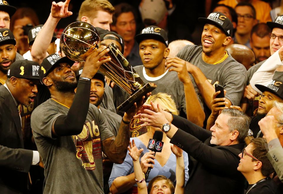 LeBron James lifts the Larry O'Brien trophy after his home-town team the Cleveland Cavaliers ended their long wait for an NBA Championship ring