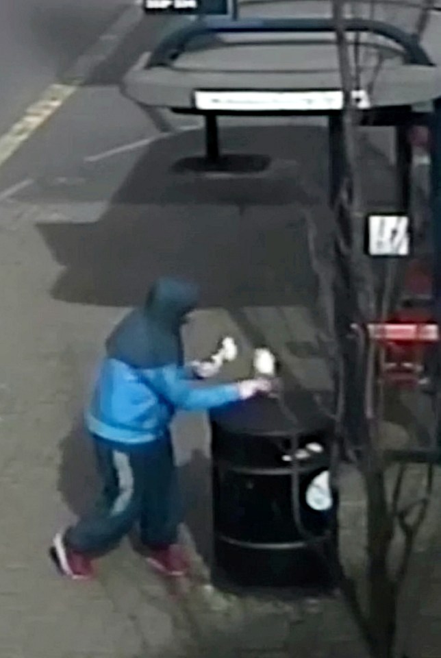  The unidentified yob is filmed lighting the petrol bomb on a bin outside the Walsall shop on Monday