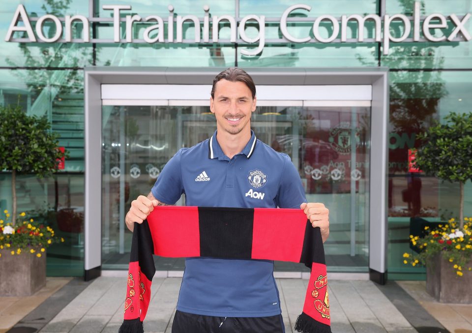  Zlatan Ibrahimovic shows his support as he holds aloft a Manchester United scarf