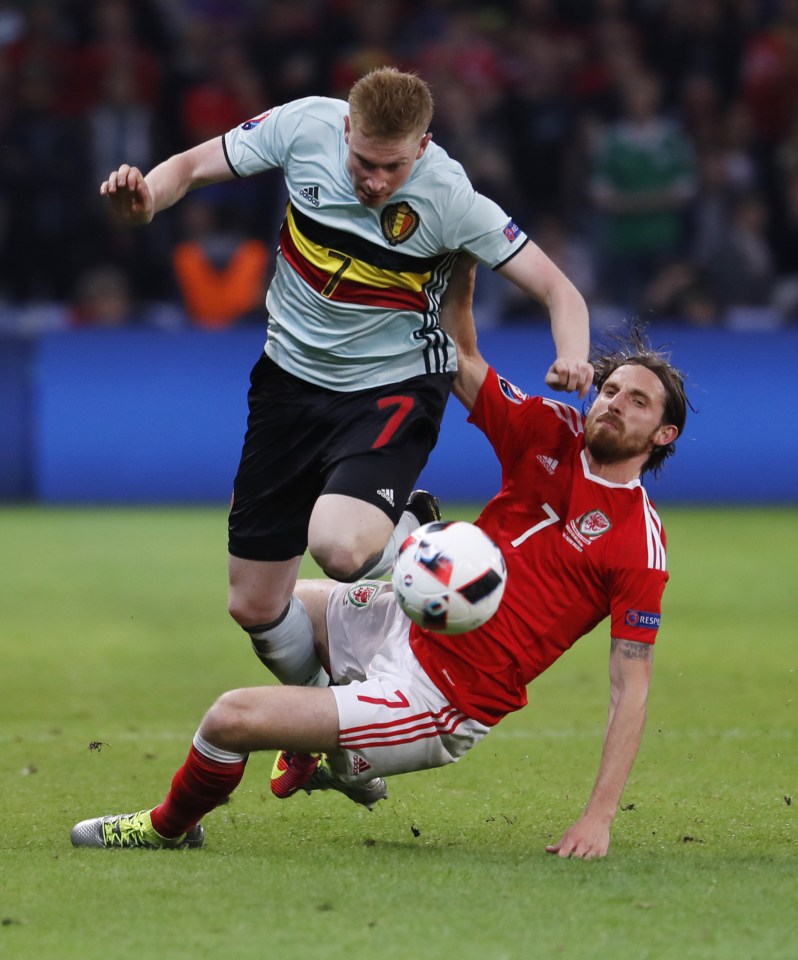 Allen puts in a challenge of Kevin De Bruyne during Wales' win over Belgium