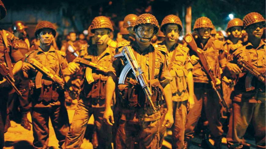  Armed response ... Soldiers stand guard during siege at the Dhaka restaurant located in the city's diplomatic quarter