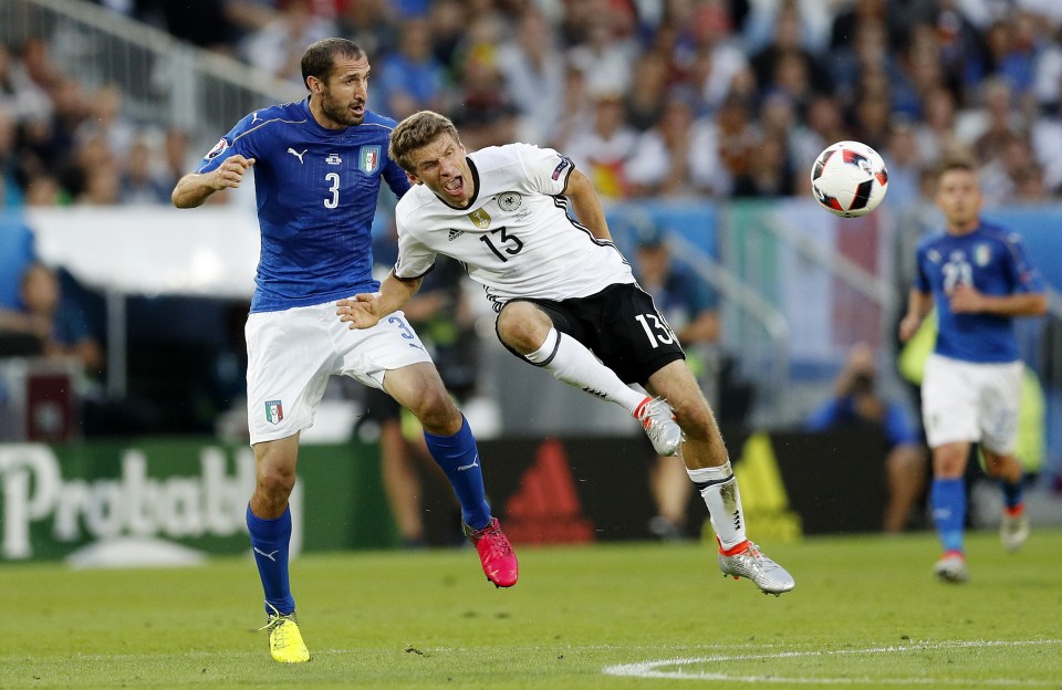  Giorgio Chiellini and Thomas Muller fight for the ball in tense quarter-final