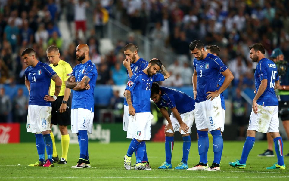  The Italian players react with dejection after Matteo Dariman's miss against Germany