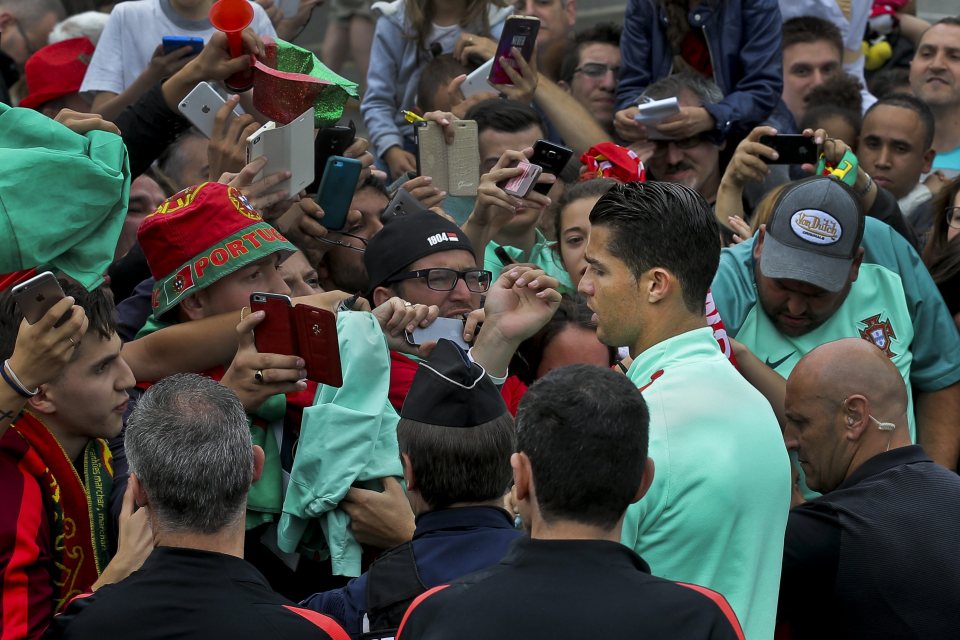  Cristiano Ronaldo is swarmed by Portugal supporters during a training session