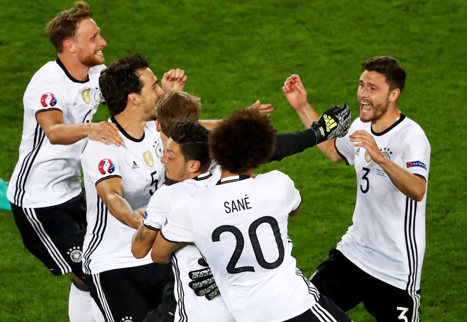  Jonas Hector celebrates with team-mates after scoring the winning penalty