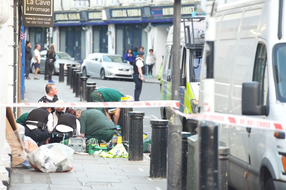  Paramedics treat the victim where he collapsed close to the bookshop from the film Notting Hill