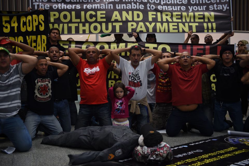 Angry officers greet visitors to Rio with some striking messages about treatment and conditions