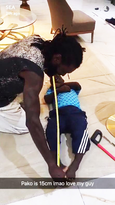  Emmanuel Adebayor appears to measure his dwarf mate Pako Rabane