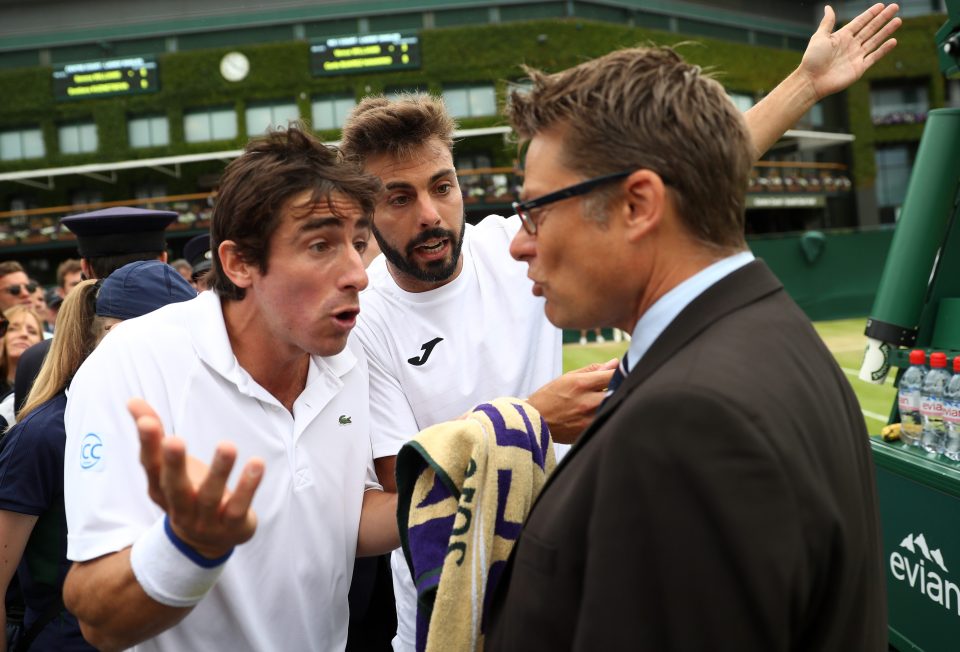  Pablo Cuevas left and Marcel Granollers right argue their case of code violation