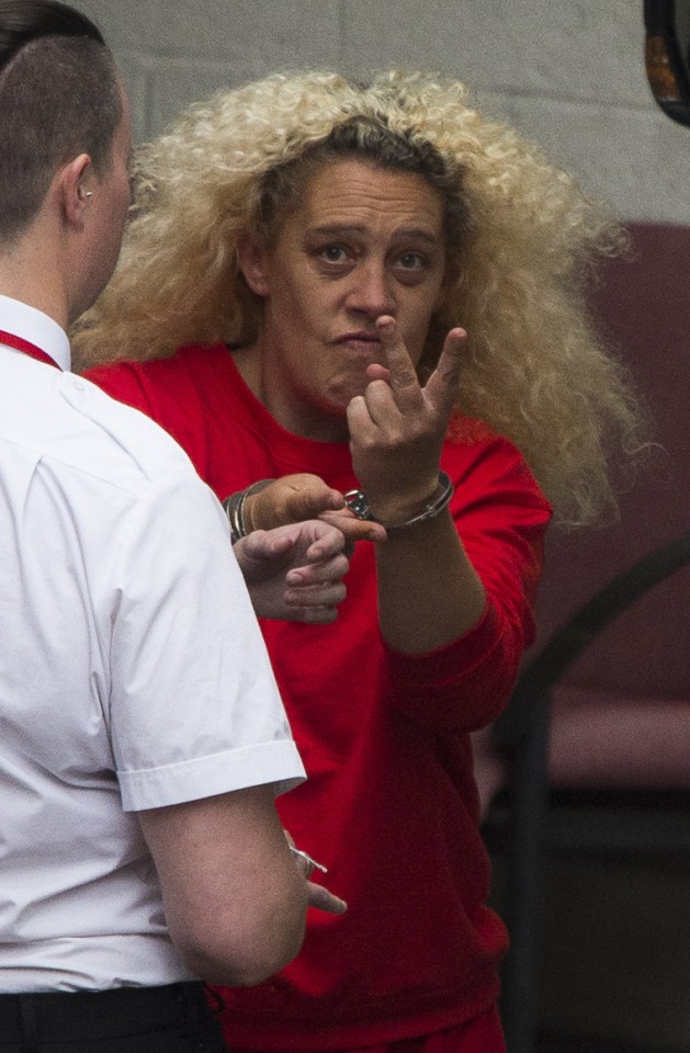  Two fingers ... Martin flips off snapper as she is led to court